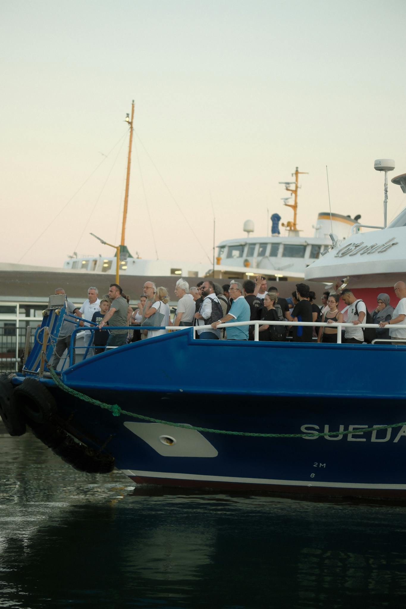People gathered on a cruise ship deck enjoying an evening voyage.